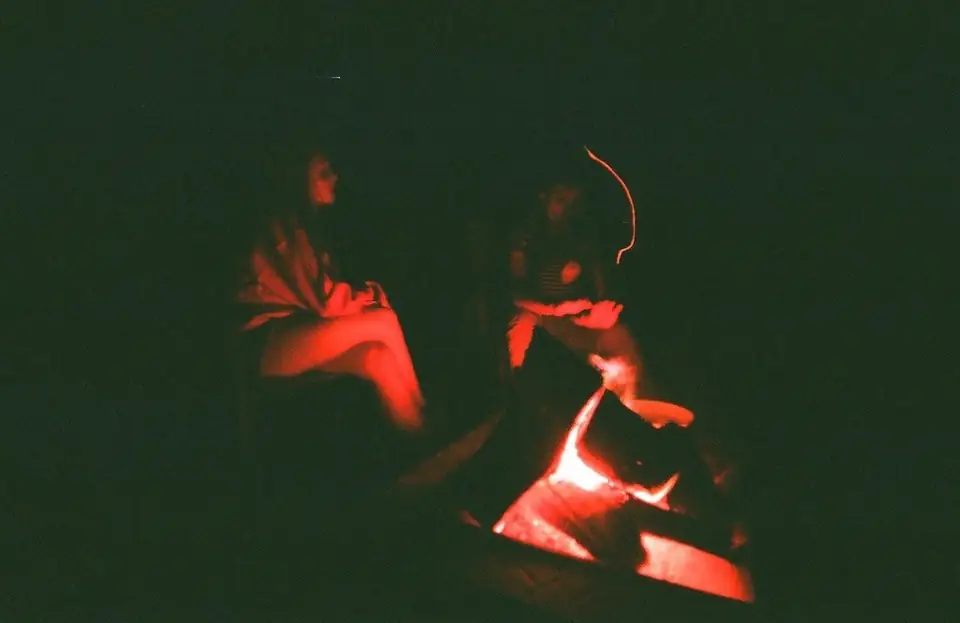People beside a fire at night.