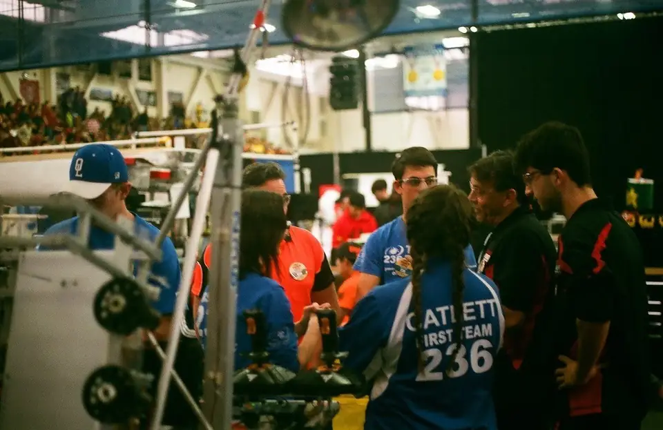 Students gathered around a competition robot.