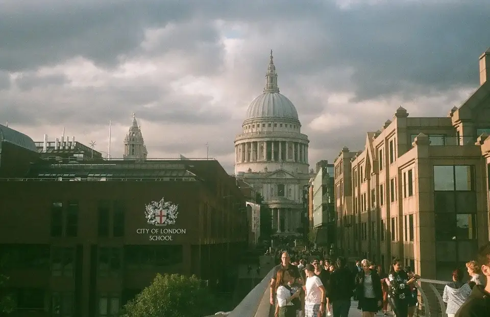 A domed building beyond a crowded street.
