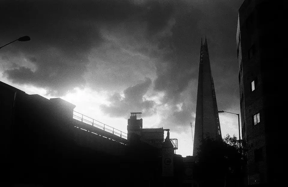 A tall pointed building silhouetted against clouds.