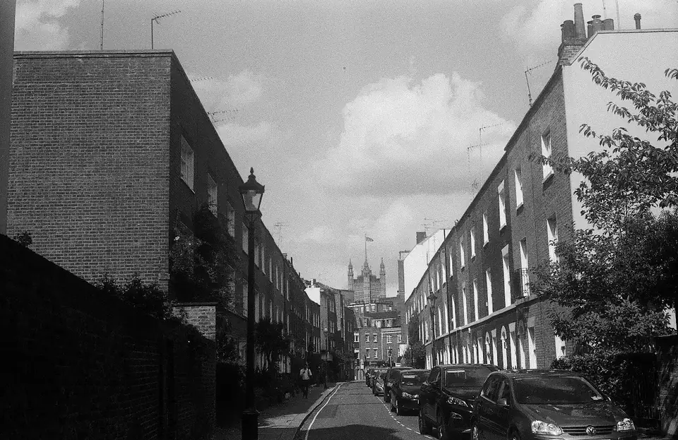 A black-and-white view down a residential street.