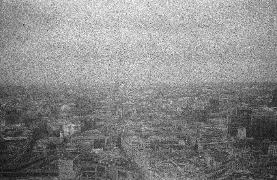 A grainy black-and-white city panorama.