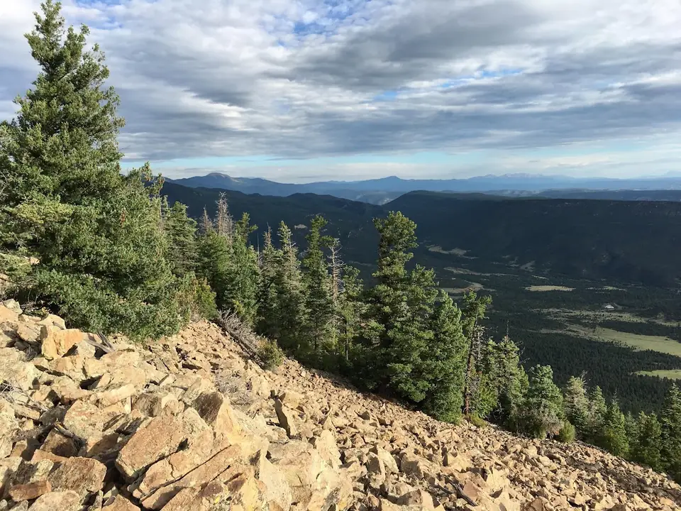 A rocky ridge above a wooded valley.