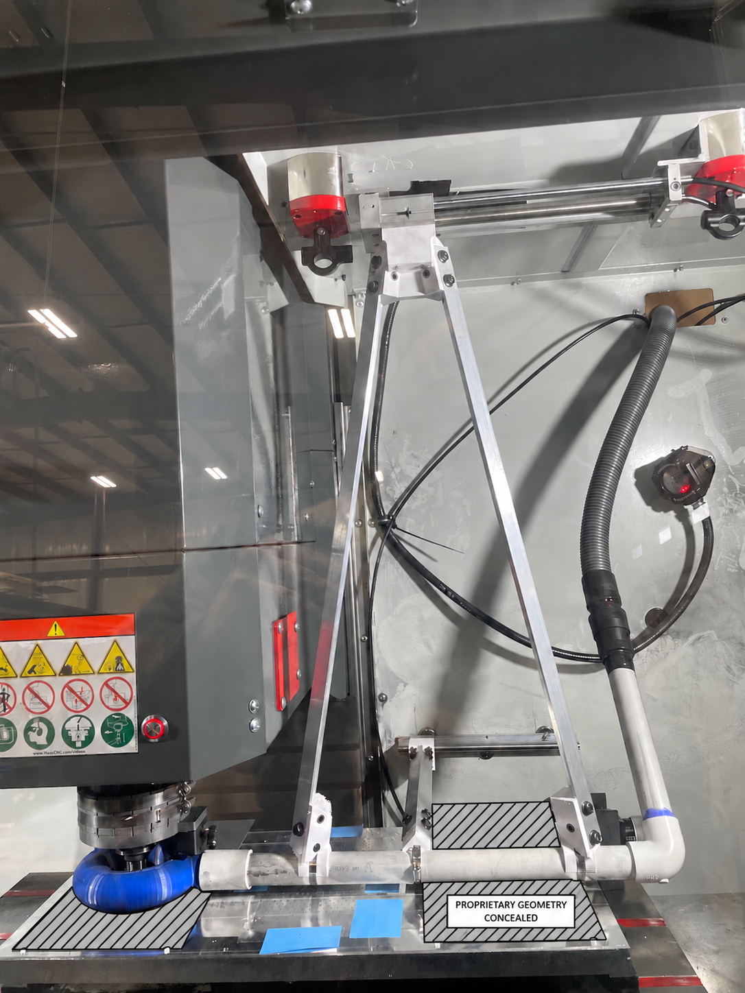 Custom dust collection system on the Haas VF-2, with proprietary flow-field geometry concealed